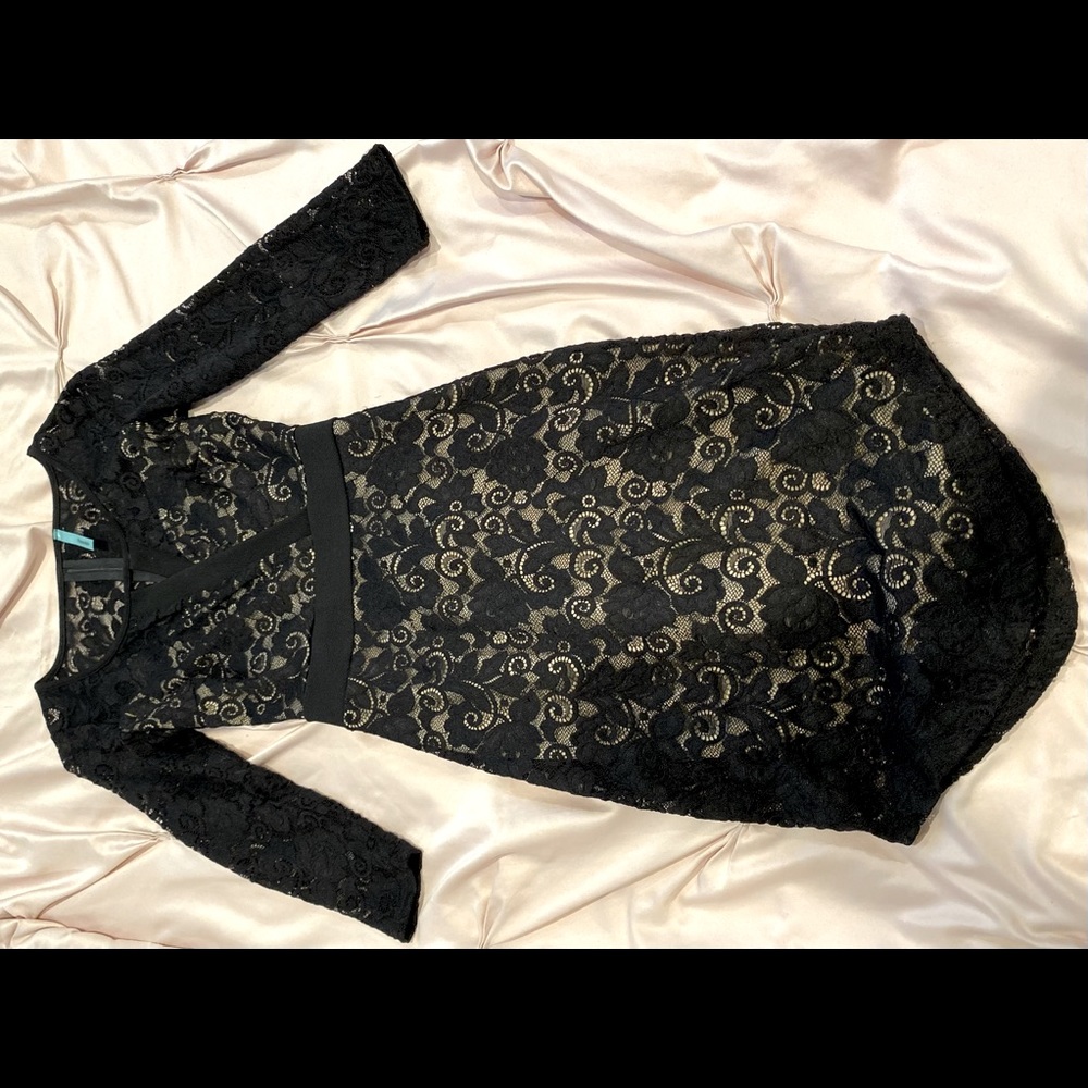 Black laced dress. Dress goes below the knee. Brings out your curves